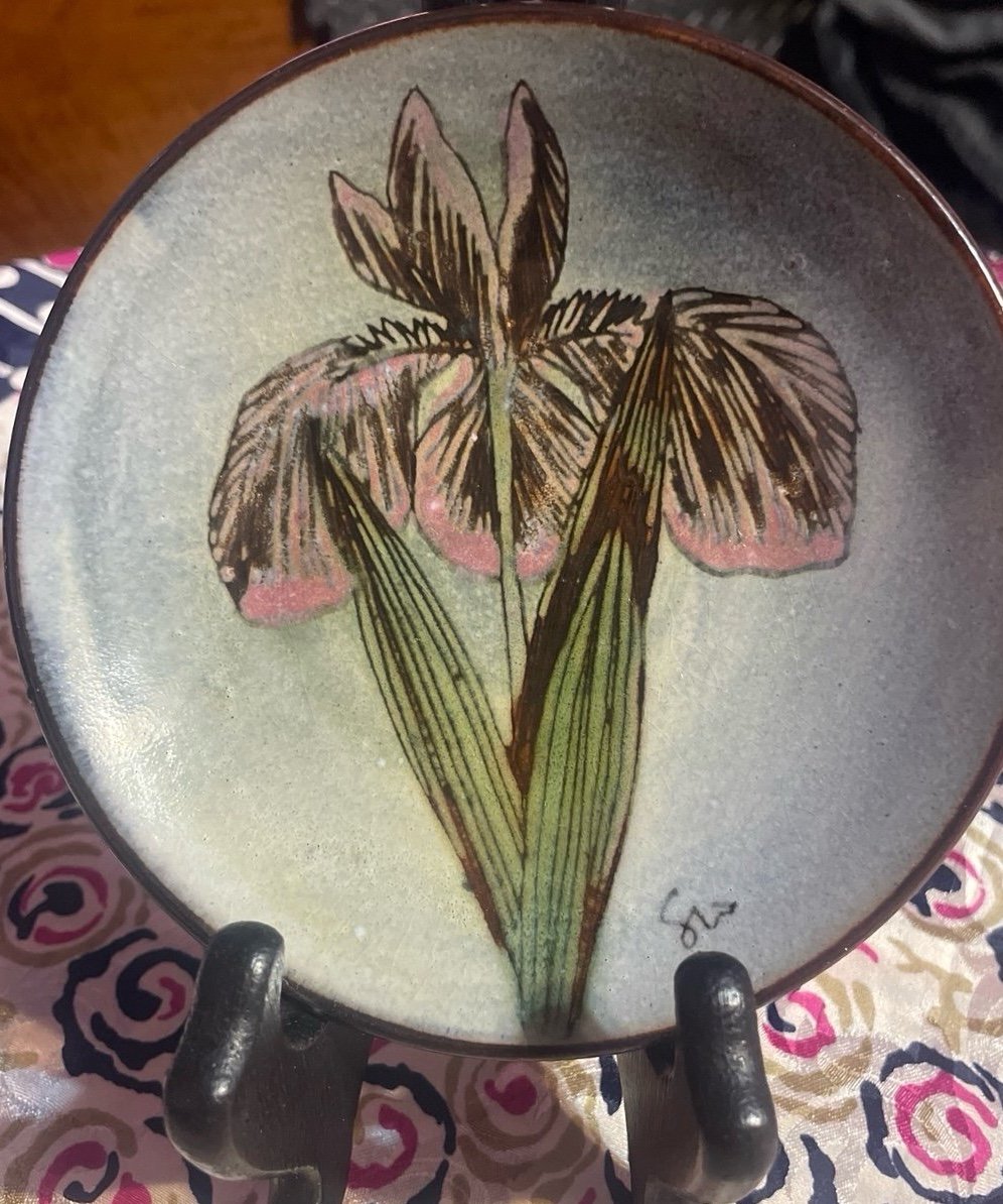 Vintage decorative plate featuring a hand painted iris.