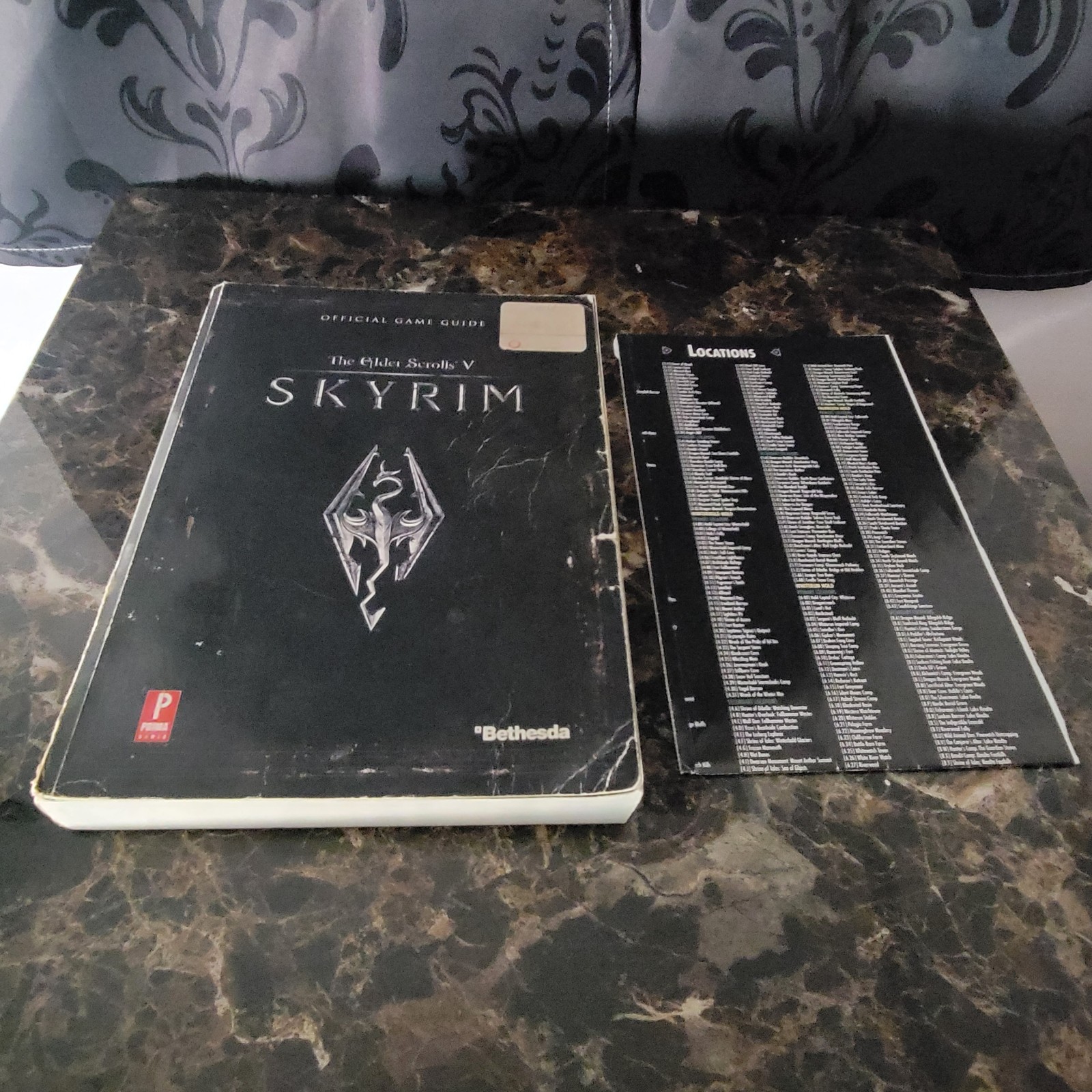 The Elder Scrolls V Skyrim Official Game Guide with its black/grid map.
