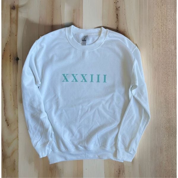 DEBT FREE est. 33 CE” Roman Numerals crewneck sweatshirt