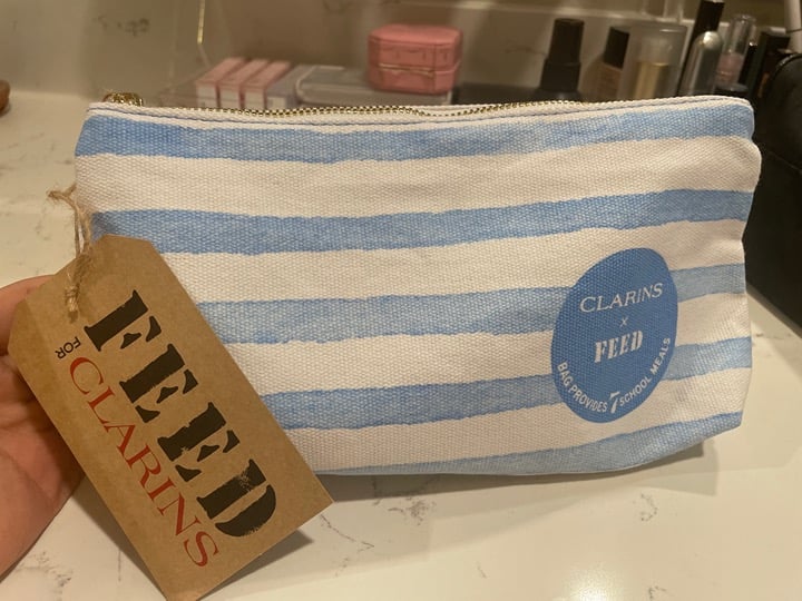 Selling fast!!! Clarins x FEED Brand New Middle size travel set!!!!