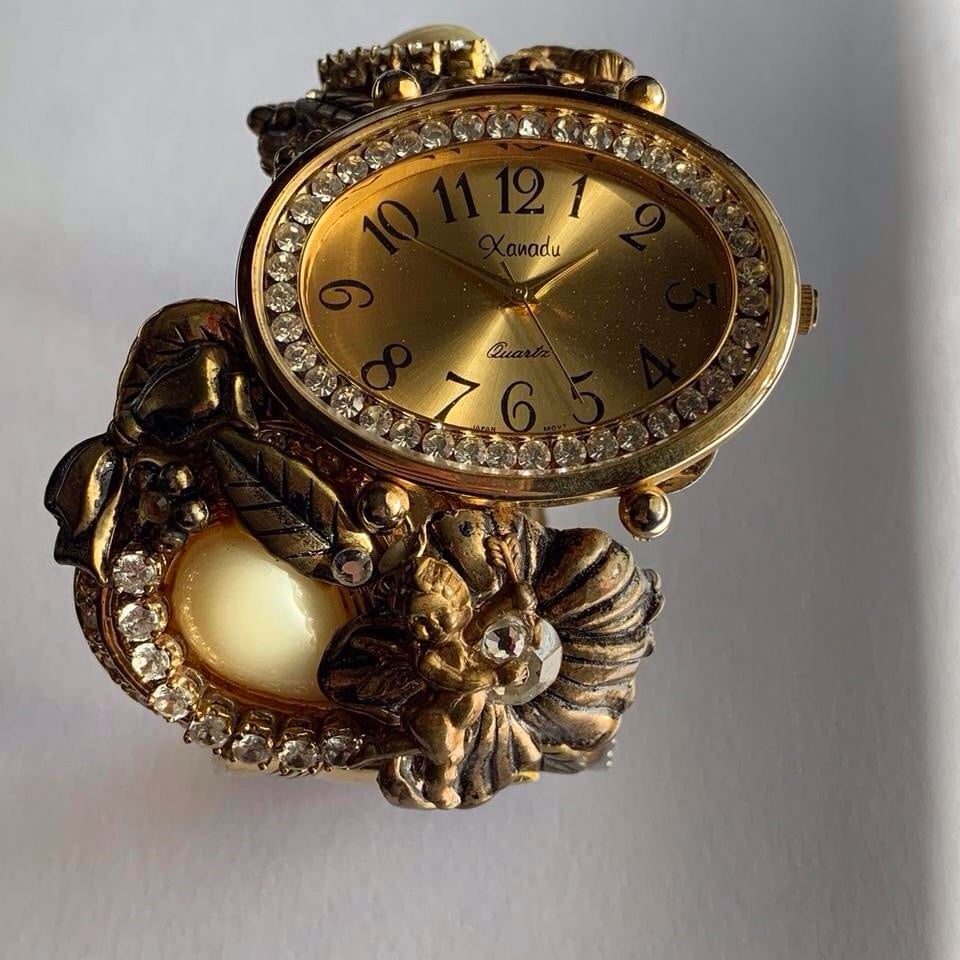 Gold tone watch with pearls, leaves, bows, diamond hand cuff bangle