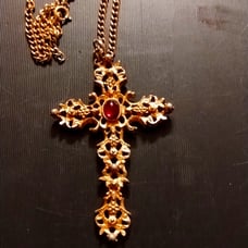 Absolutely beautiful bejeweled gold cross necklace with Ruby in the middle