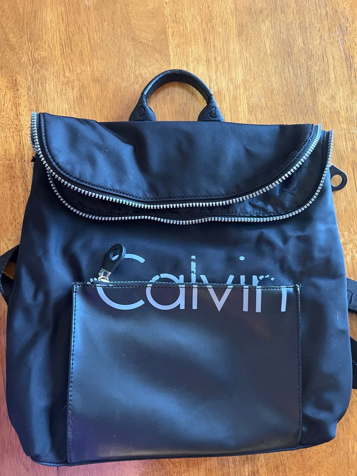 GUC Calvin Klein backpack. Black with distressed lettering. Lots of pockets!