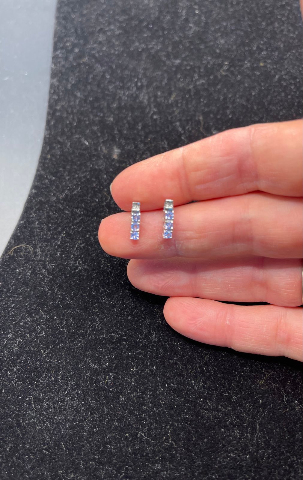 Earrings 10 karat white gold with diamond chip and 3 light blue stones 110921@