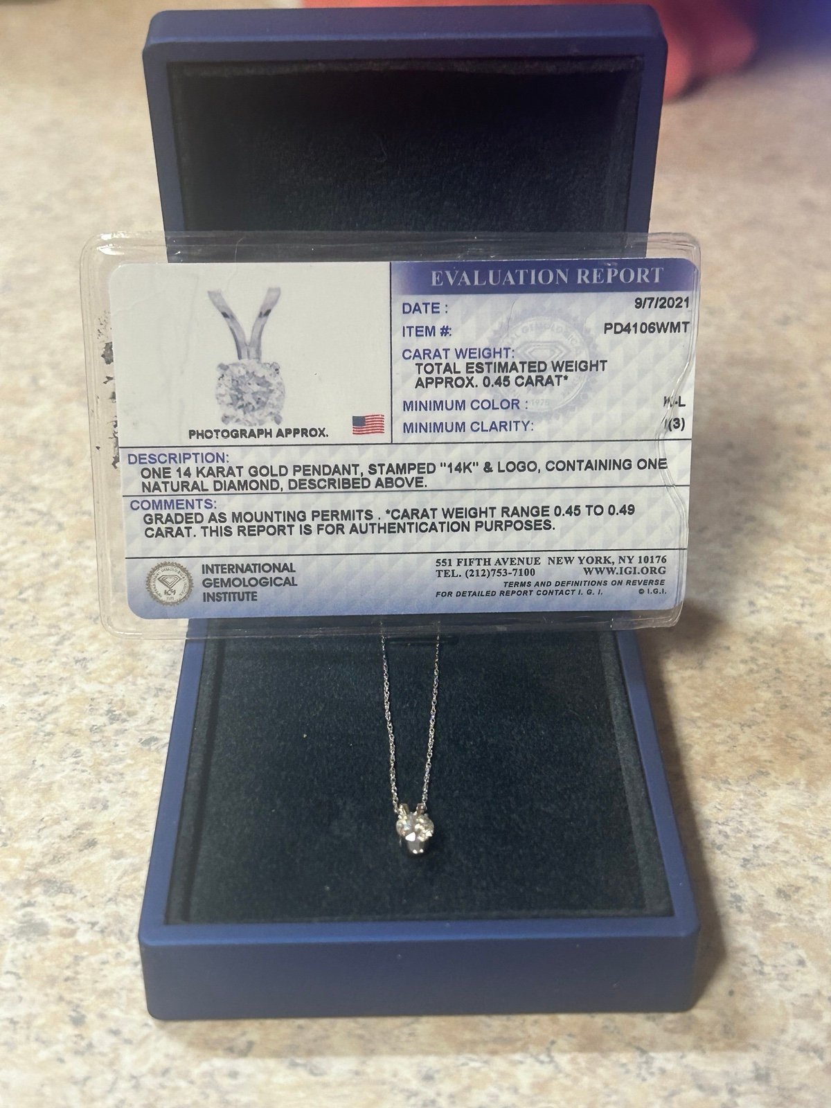 ONE 14 KARAT GOLD PENDANT, STAMPED 14K & LOGO, CONTAINING ONE NATURAL DIAMOND