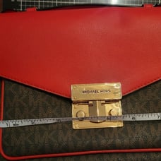 Michael Kors dark brown with red flap. Paid 104 original price 298.