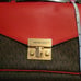 Michael Kors dark brown with red flap. Paid 104 original price 298.