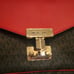 Michael Kors dark brown with red flap. Paid 104 original price 298.