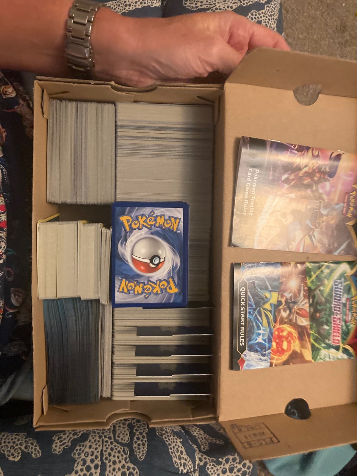 A shoebox full of various Pokémon cards.