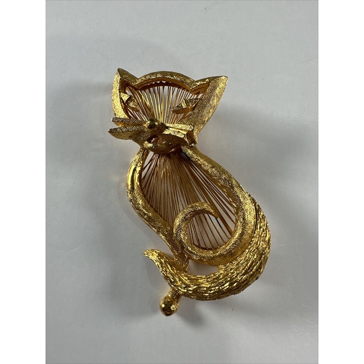 MCM gold tone cat signed by Monet very intricate working of the material