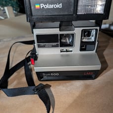 Polaroid Sun 600 LMS Camera With A Strap. Still Has Film In It, But Its Old, The