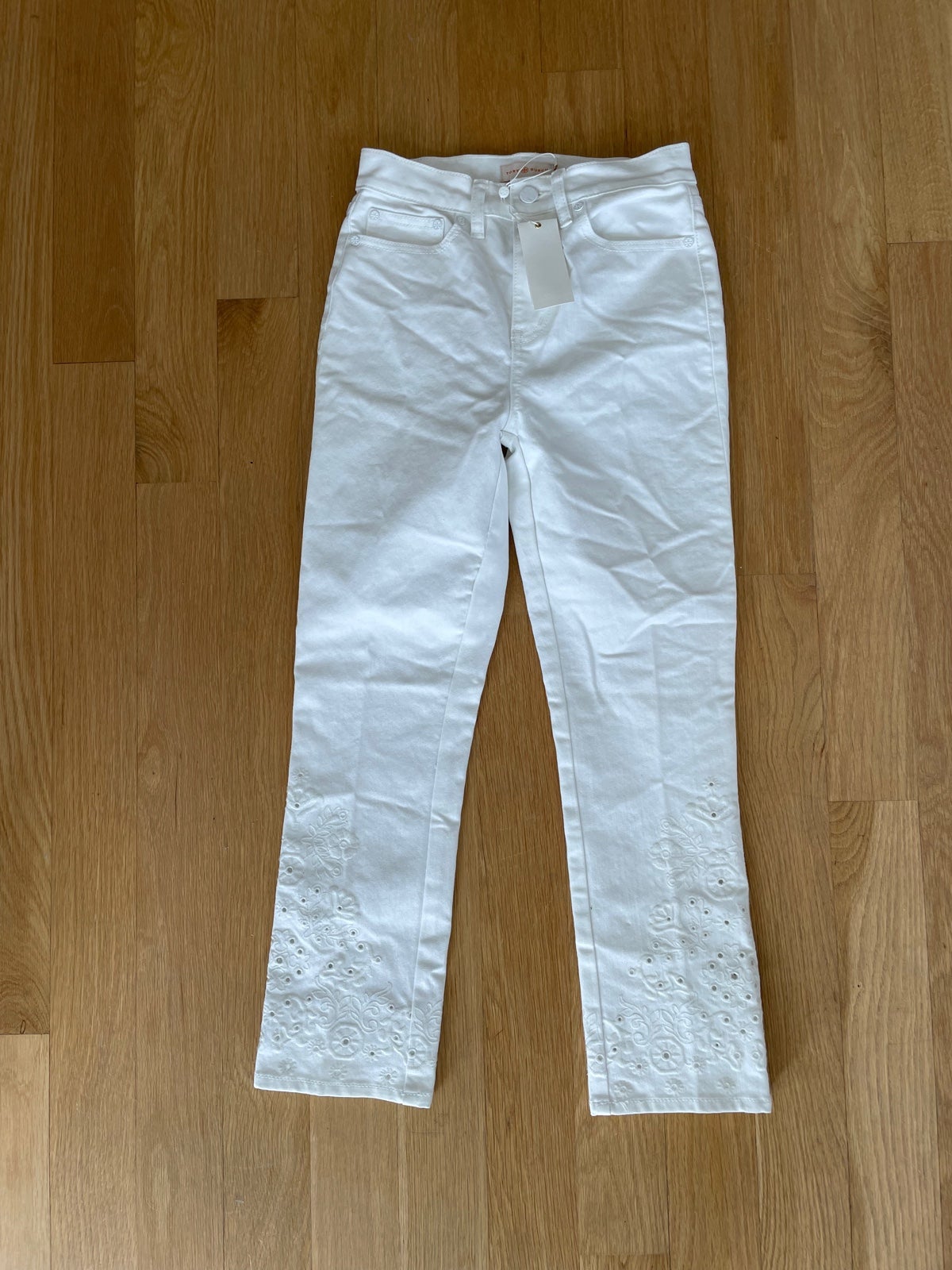 White Tory Burch Keira Jeans with eyelets on the bottoms. Super cute!
