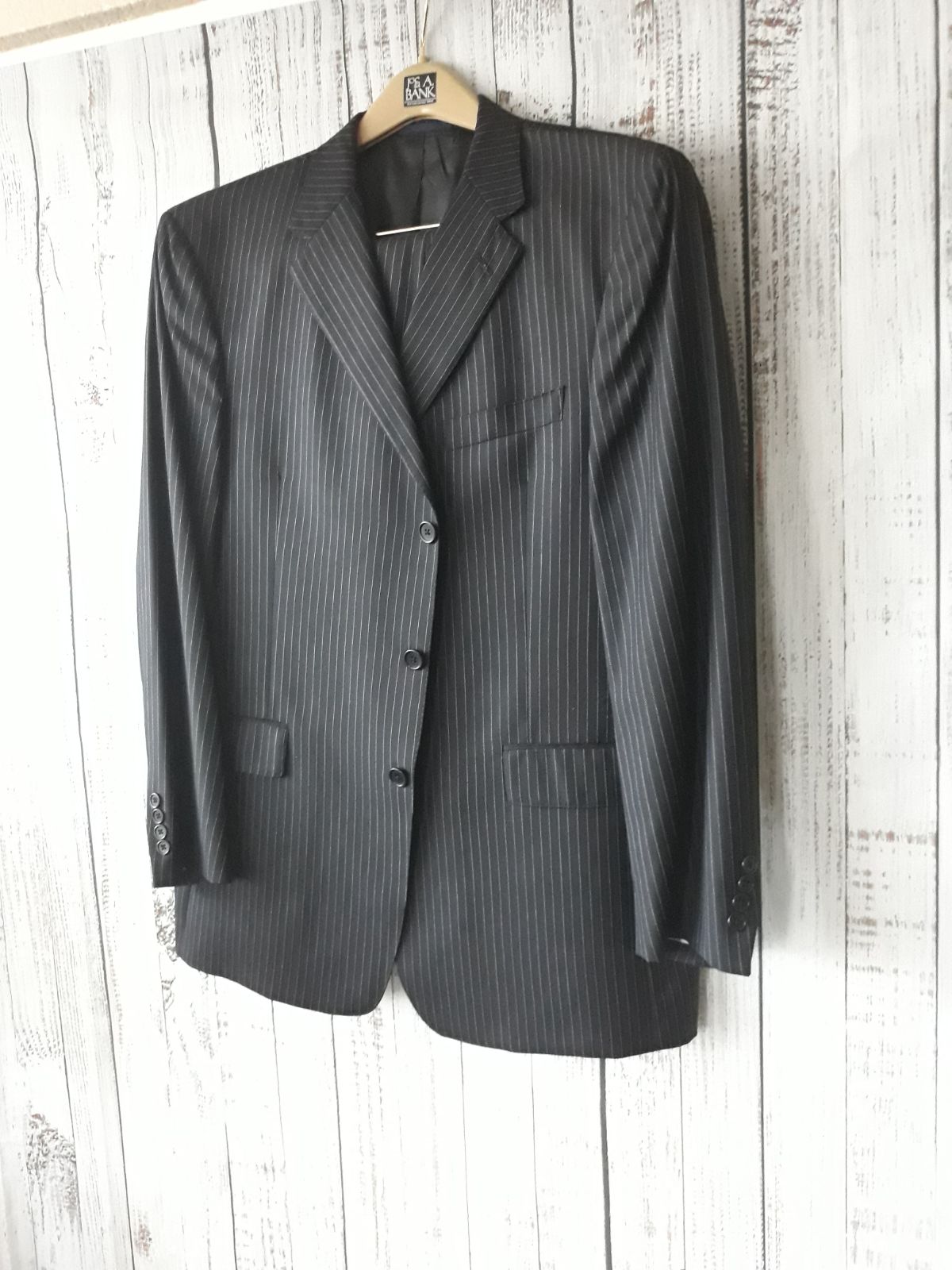 Suits with pleated pants.