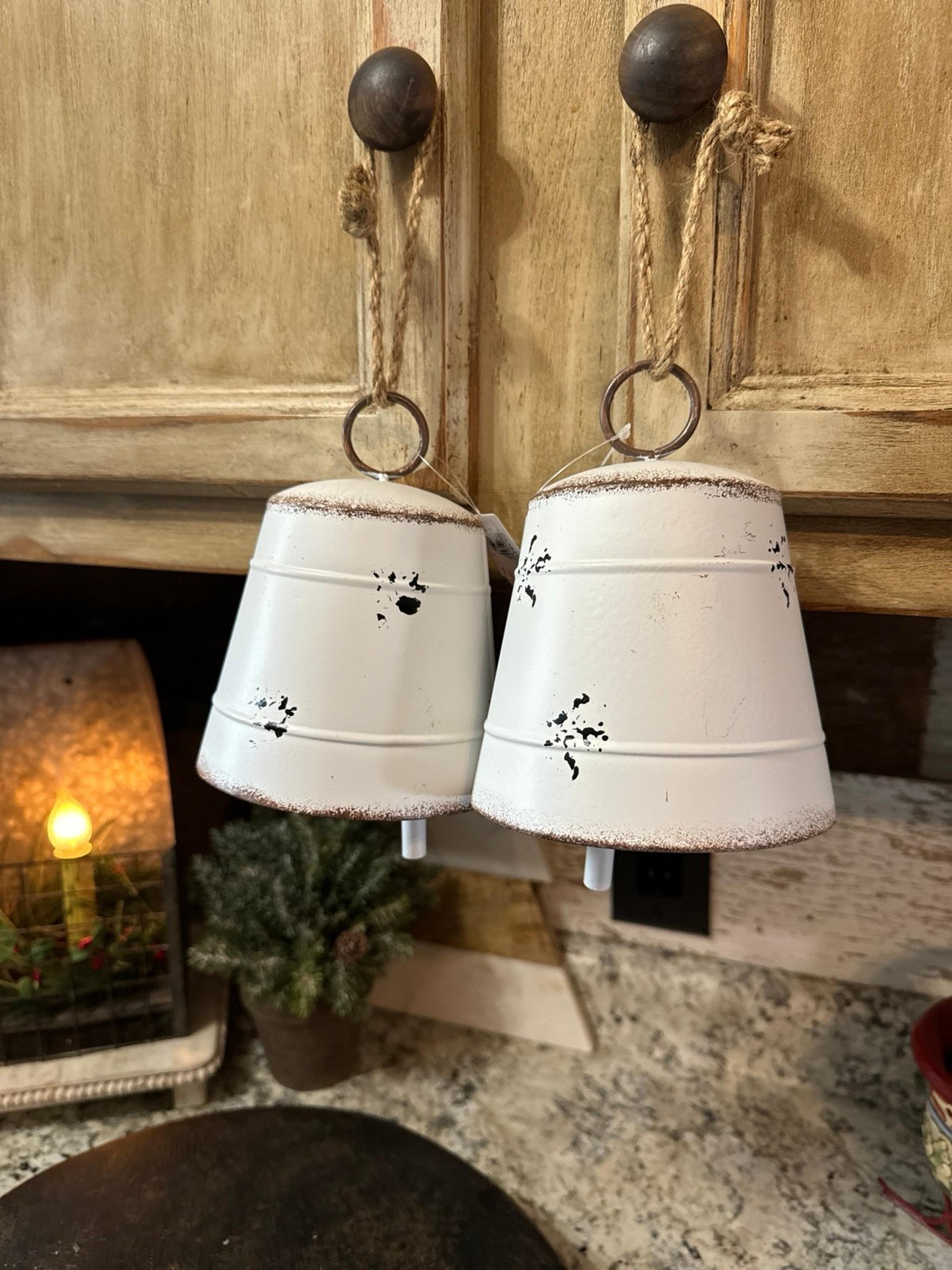 2 white metal bells
