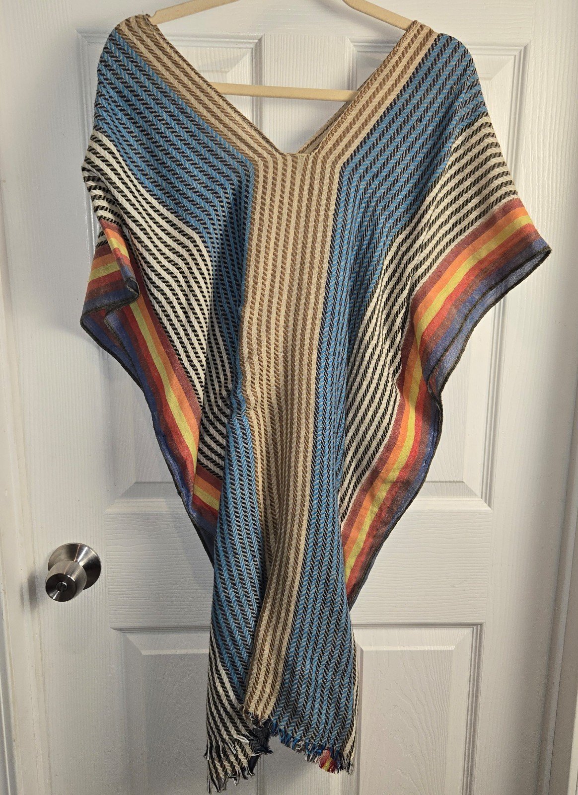 Free People one-size poncho featuring a V-neck and multi-colored stripes