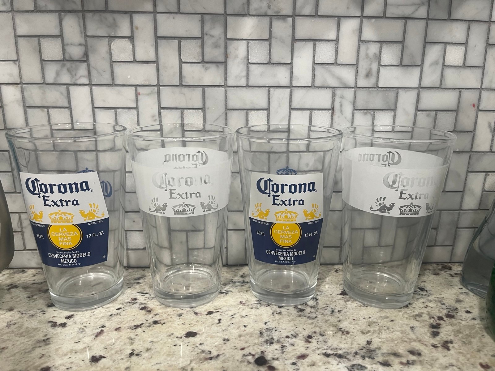 4 Corona Pint Glasses. 2 w/Blue,White,&Gold images. 2 White w/clear. NWOT