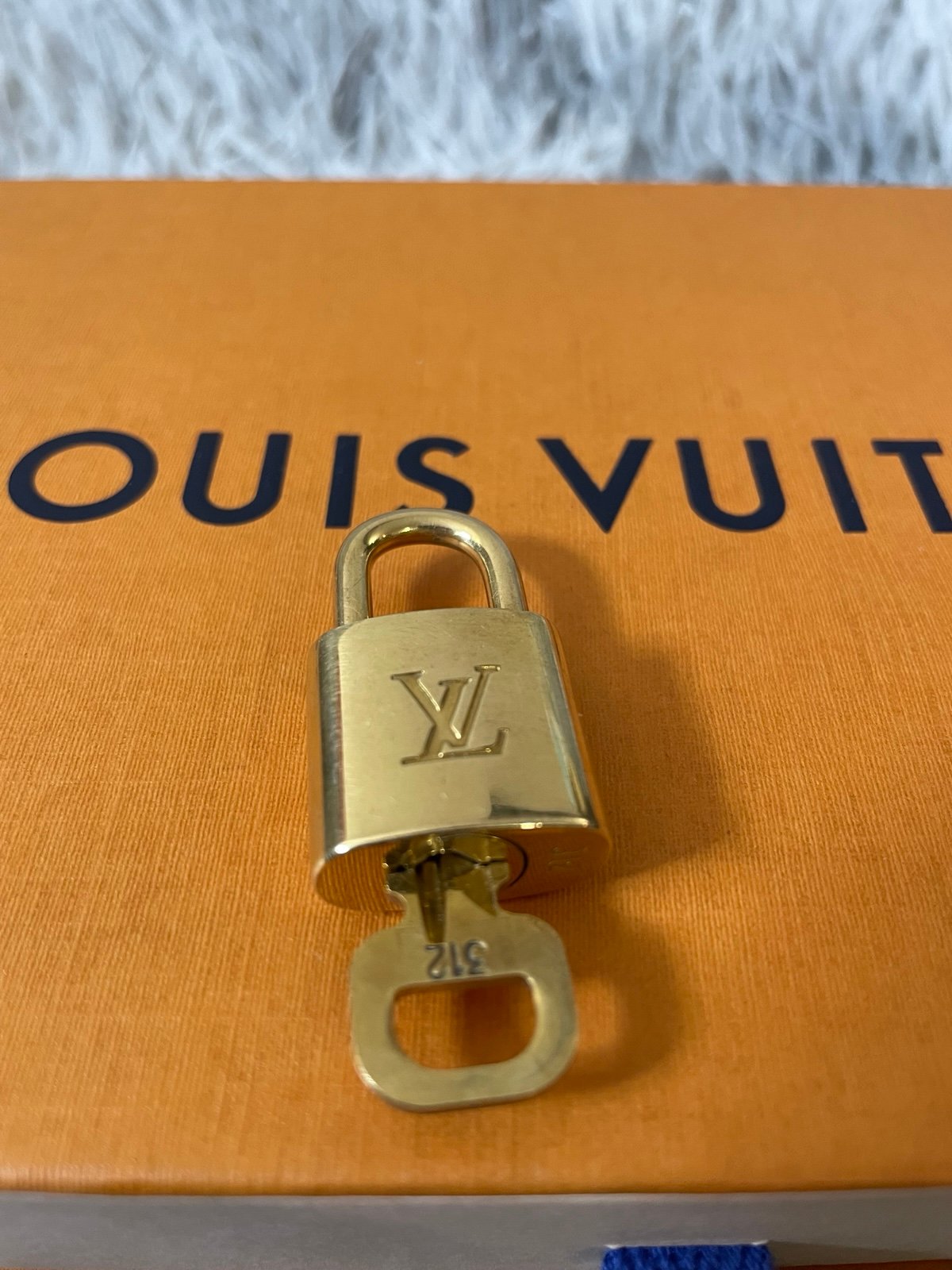 Louis Vuitton padlock with key number 312 no box