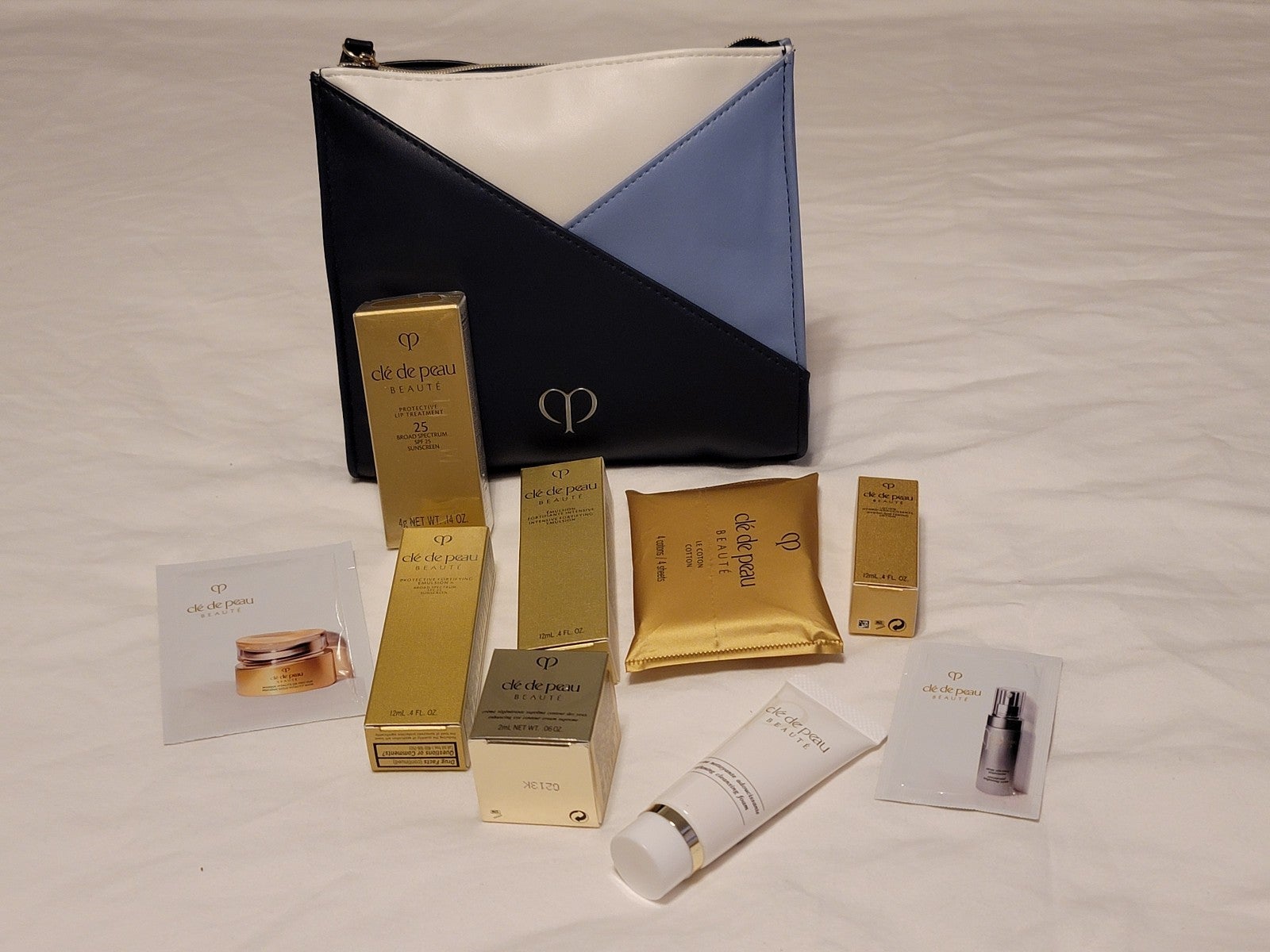 CLE DE PEAU PROTECTIVE LIP TREATMENT and a Set of Travel Size SKIN CARE
