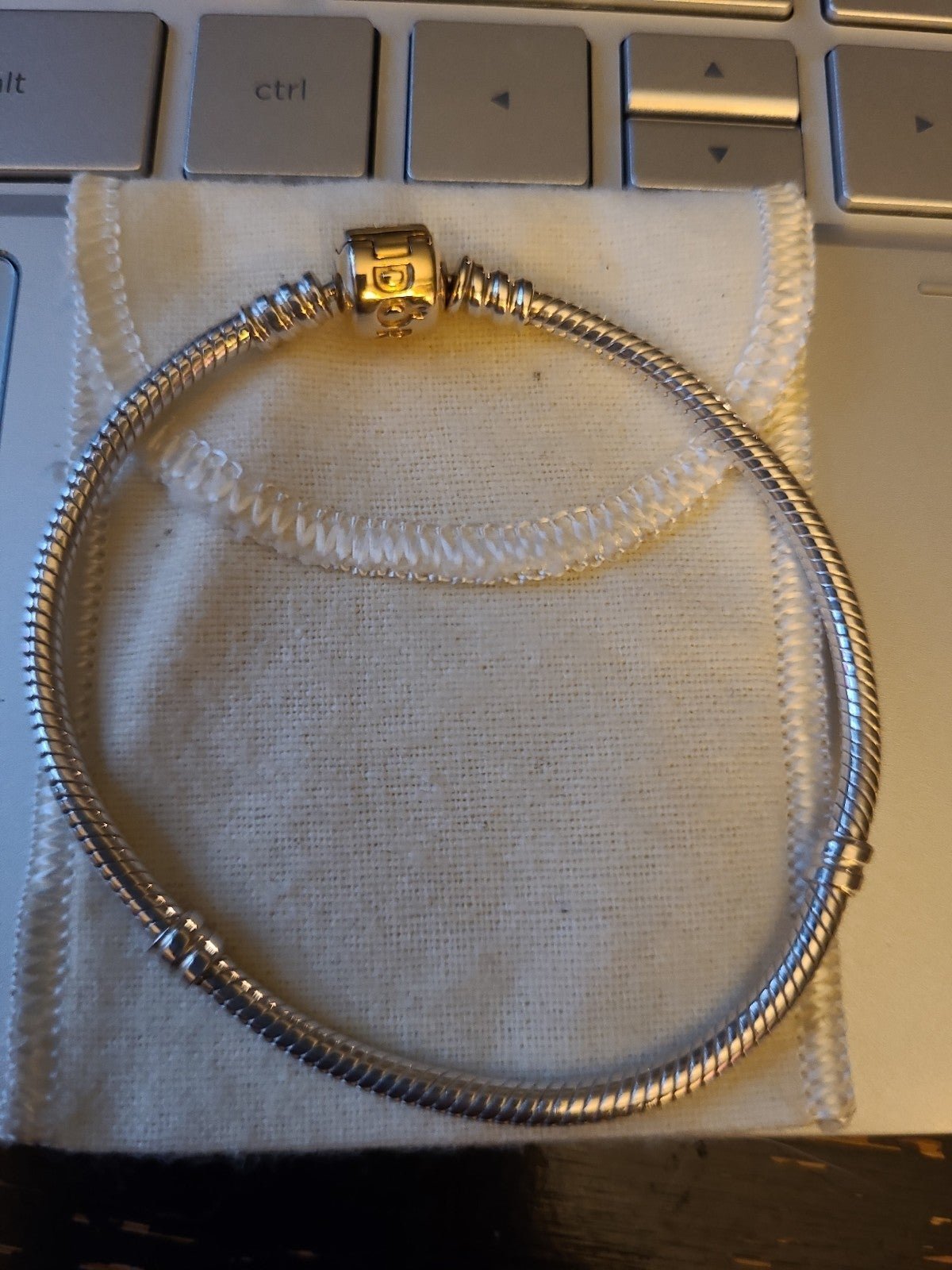 14k gold clasp Pandora bracelet and silver snake bracelet with heart clasp