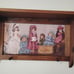 Vintage wood crafted wall shelf with pegs and a Victorian themed period print