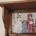 Vintage wood crafted wall shelf with pegs and a Victorian themed period print