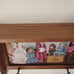 Vintage wood crafted wall shelf with pegs and a Victorian themed period print