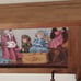 Vintage wood crafted wall shelf with pegs and a Victorian themed period print