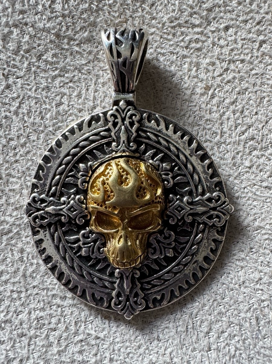 Golden skull cross pendant