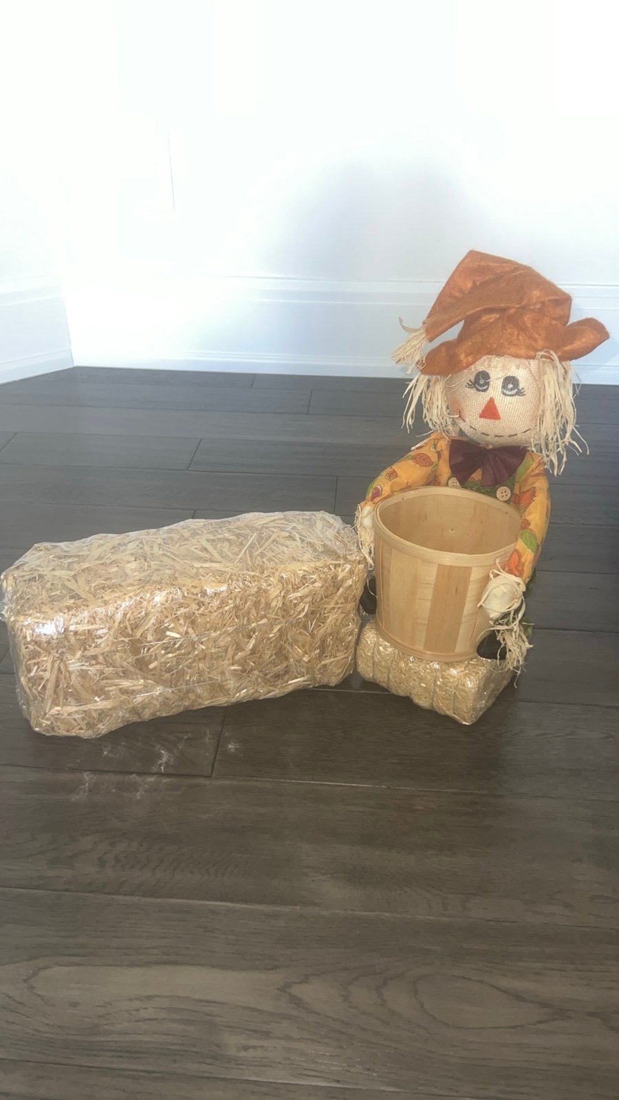 Scarecrow figurine with straw Bale
