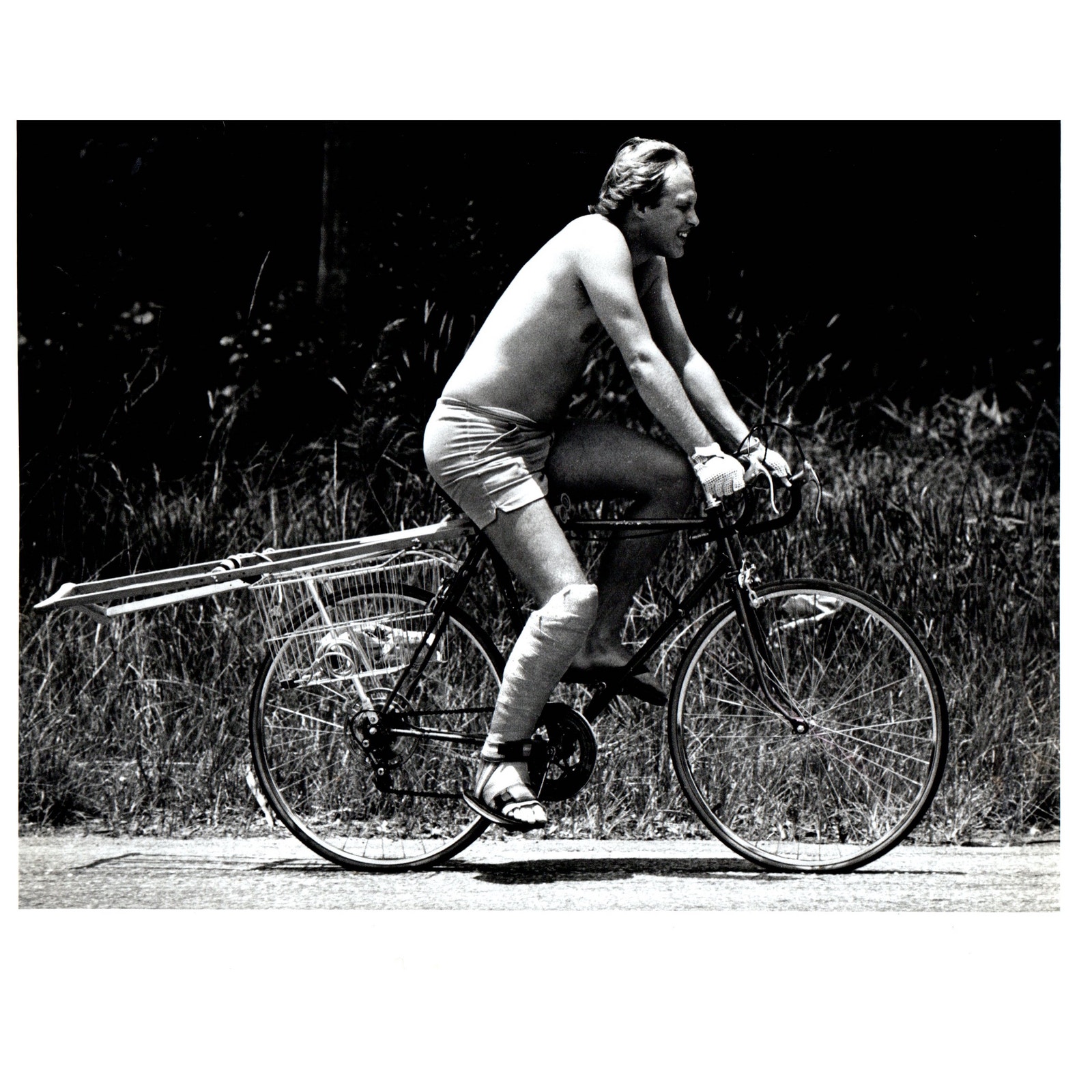 1982 Press Photo Shirtless Man Short Shorts Riding Bike on Crutches 8x10 AD3