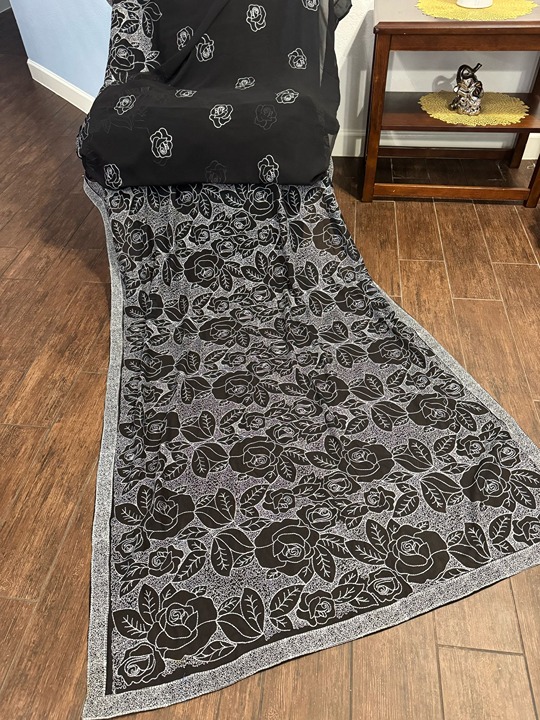 Trendy fully embroidered black saree with plain black blouse piece.