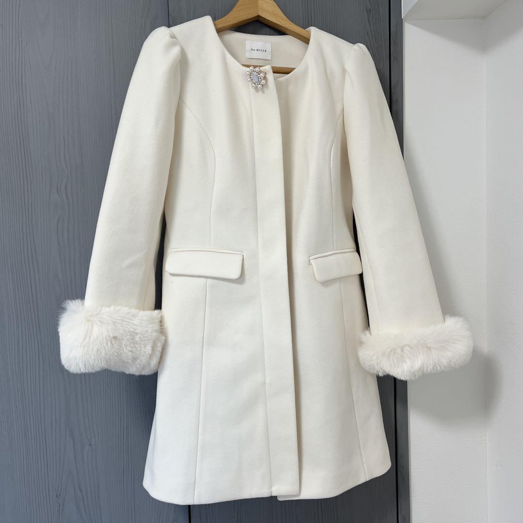 White long coat with fur-trimmed sleeves.
