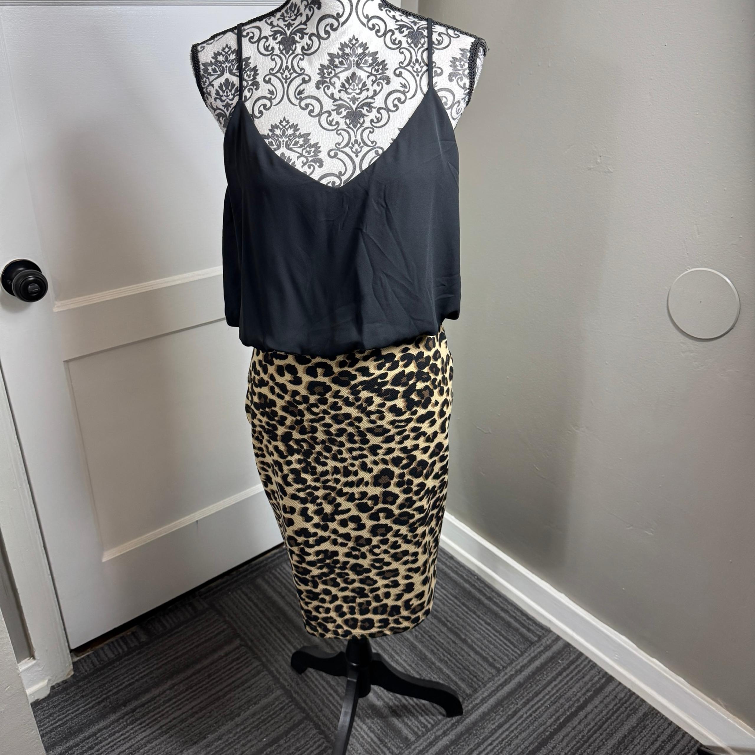 Guess black and cheetah print dress figure flattering.  Size large