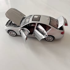 silver 1:18 scale model of a BMW 5 Series 550i (F10) By Norev