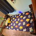Twin size wooden bed with shelf on one side.