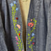 Vintage floral embroidered denim jacket purchased from a thrift store.