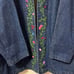 Vintage floral embroidered denim jacket purchased from a thrift store.
