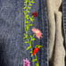 Vintage floral embroidered denim jacket purchased from a thrift store.