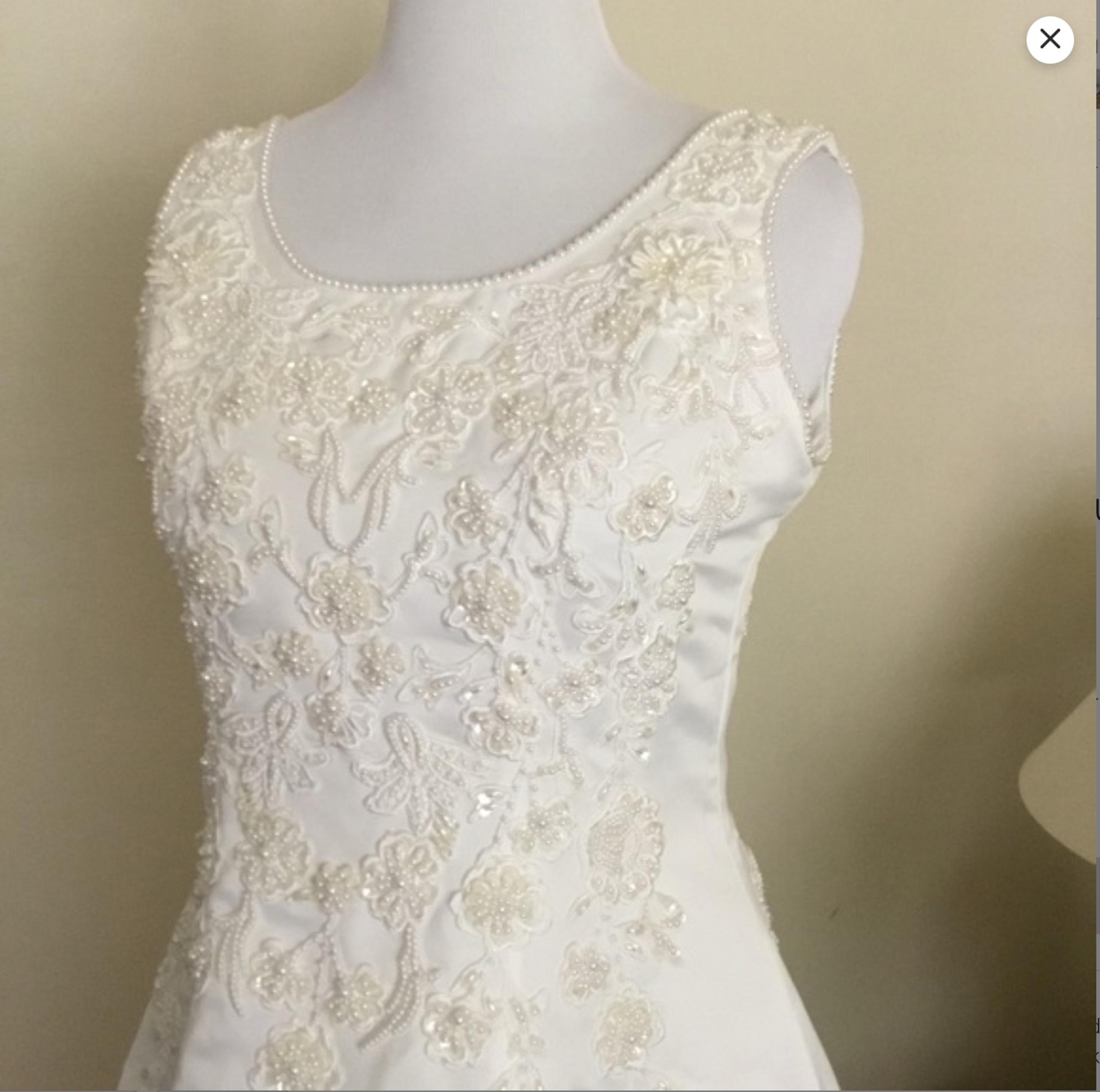 Wedding Dress Size 16. The dress feels substantial and romantic.