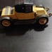 Black and yellow old-timey Corgi classic car