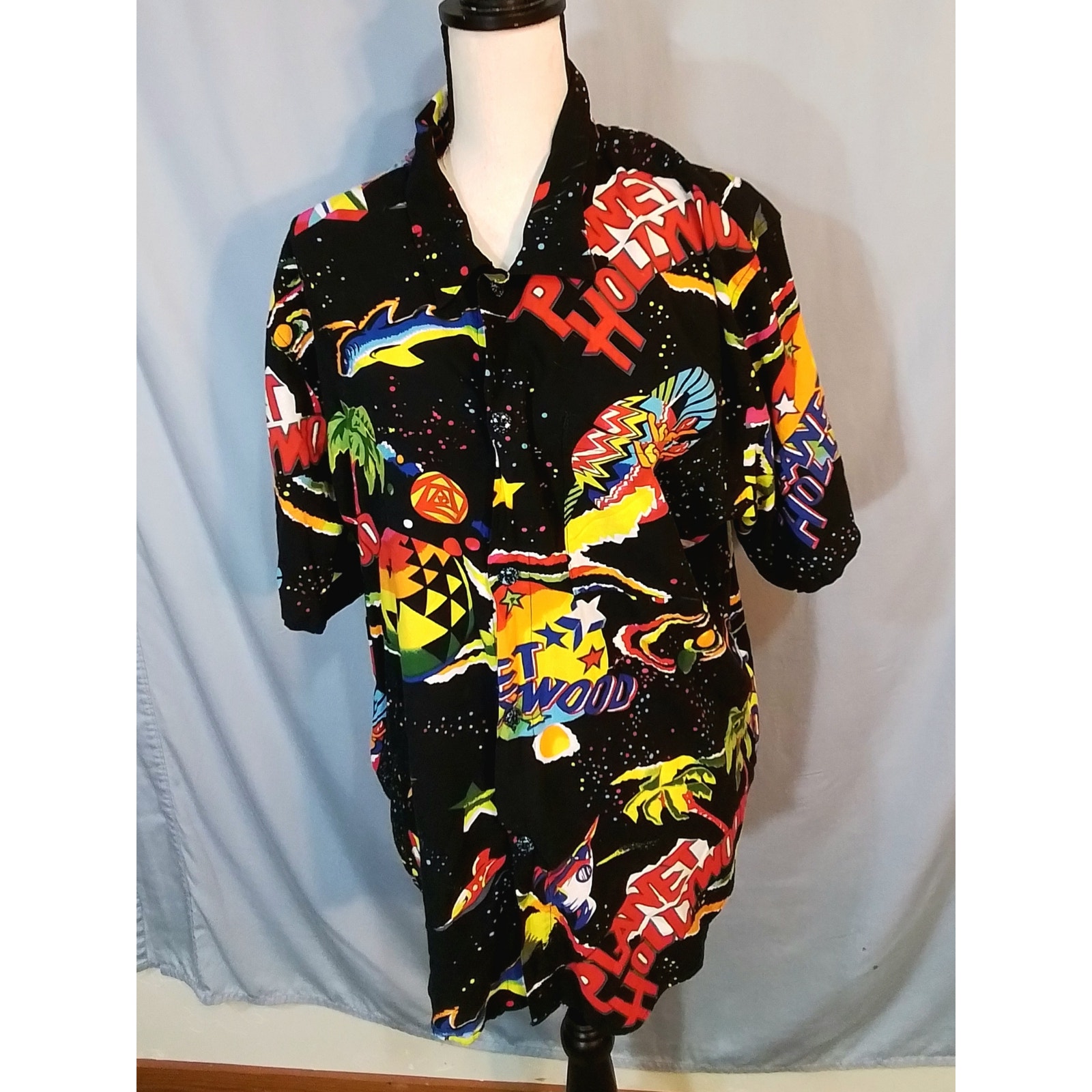 Planet Hollywood ; Colorful shirt; Black background
