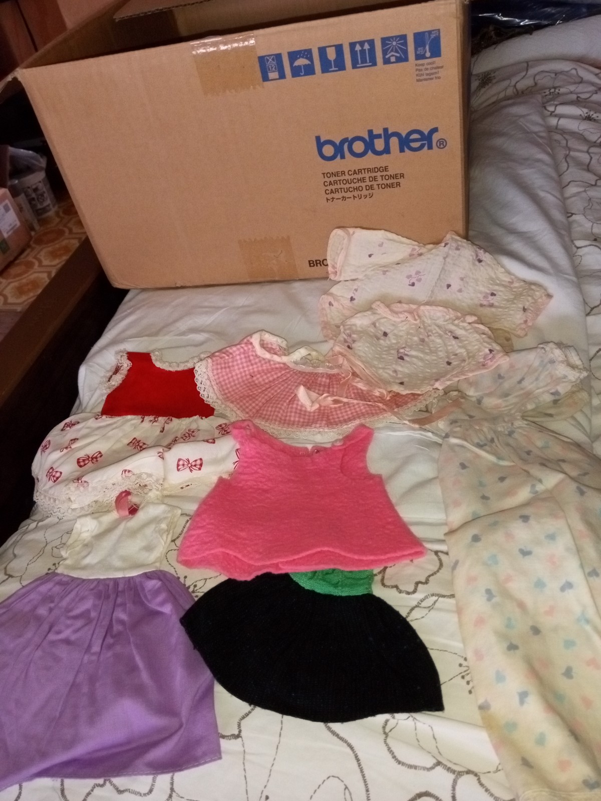 Box of vintage doll clothes