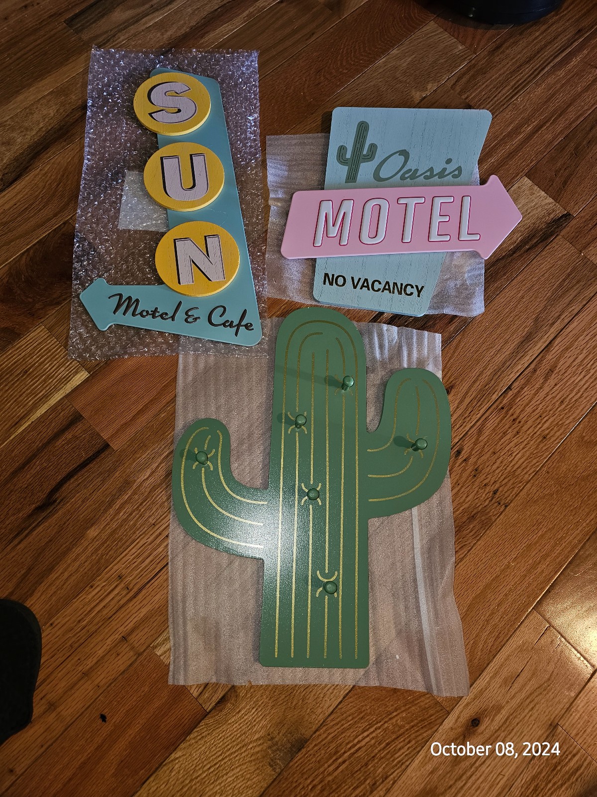 target cactus wall sign, metal sun sign, and no vacancy sign..