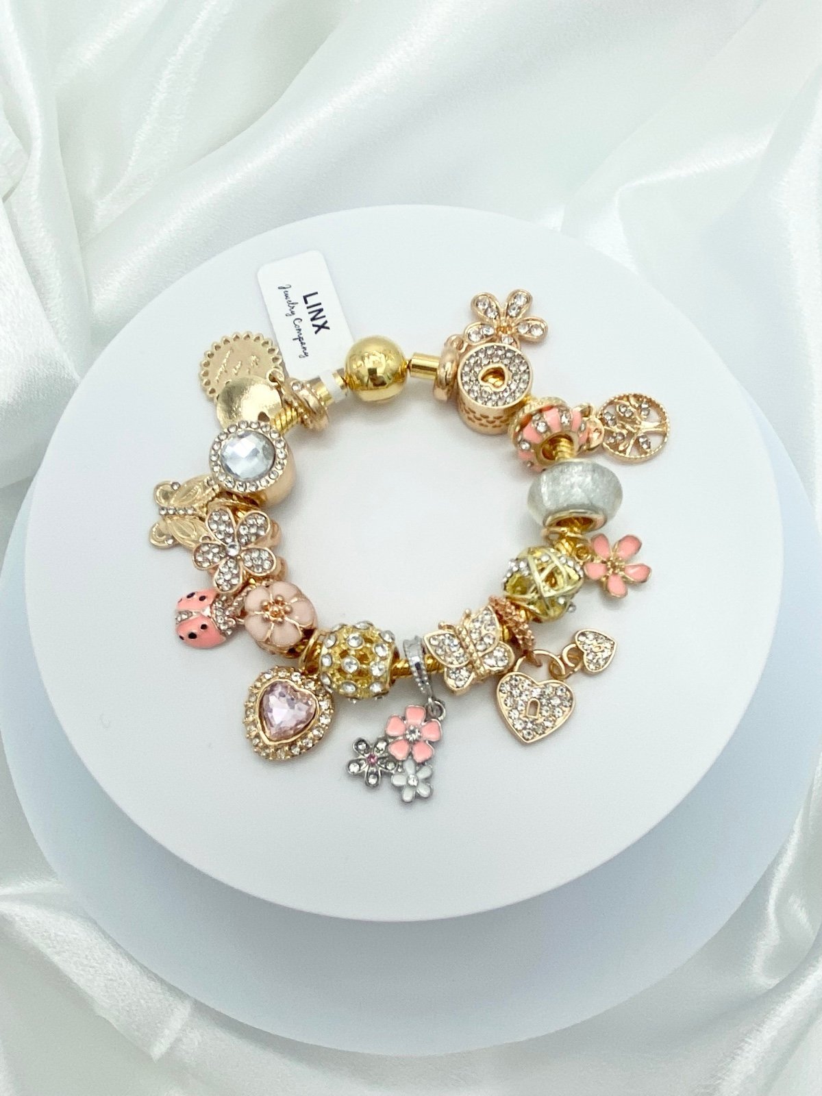 Linx Yellow Gold Snake Chain Bracelet with Gold and Peach Themed Charms
