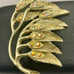 Vintage Gold Tone Leaf Brooch with Rhinestones and Intricate Branch Detailing
