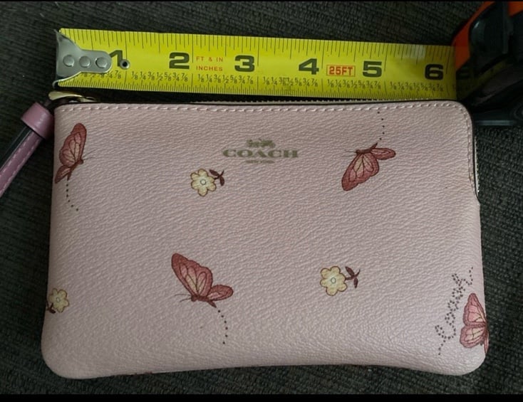 Beautiful pink butterfly clutch with zipper and wrist strap.