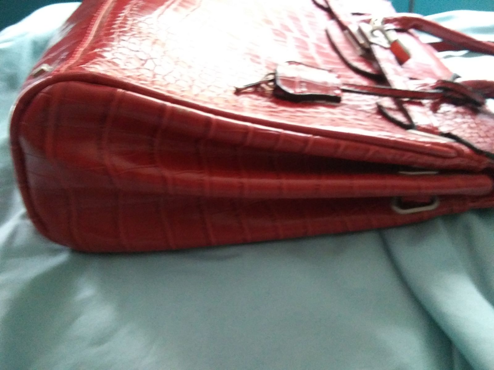 Red crocodile textured handbag