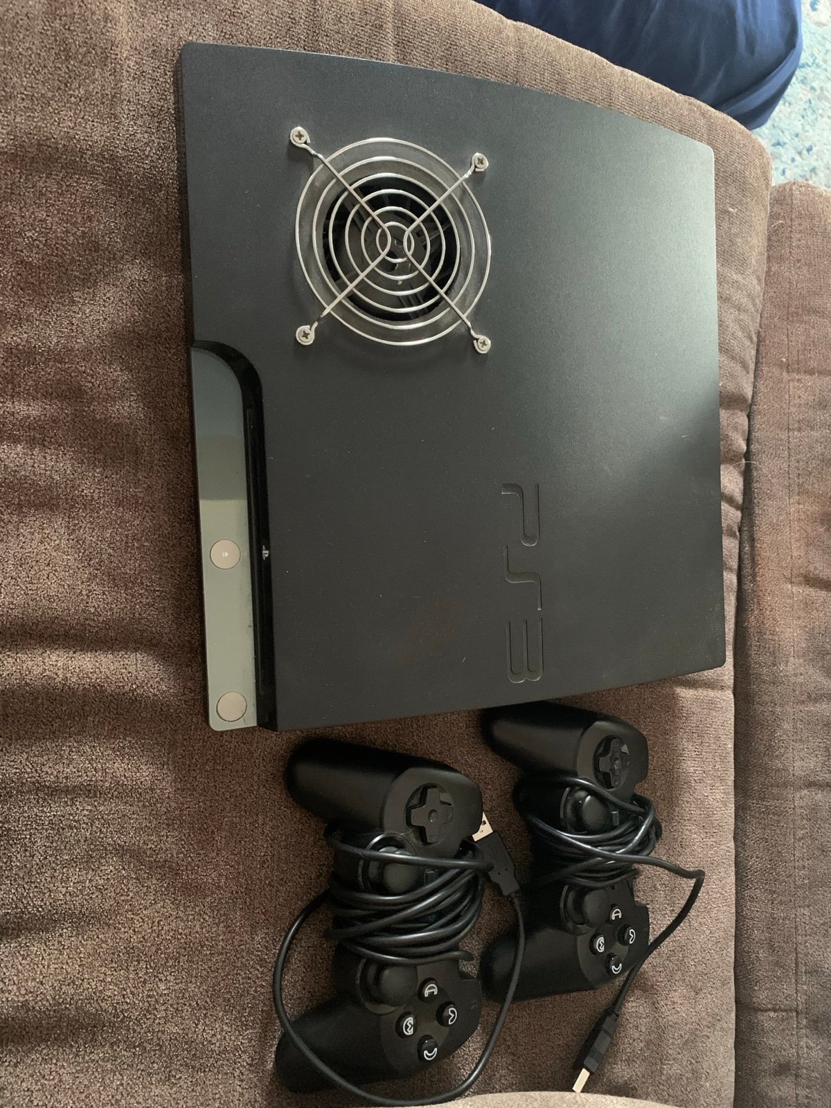 PlayStation 3 and two controllers