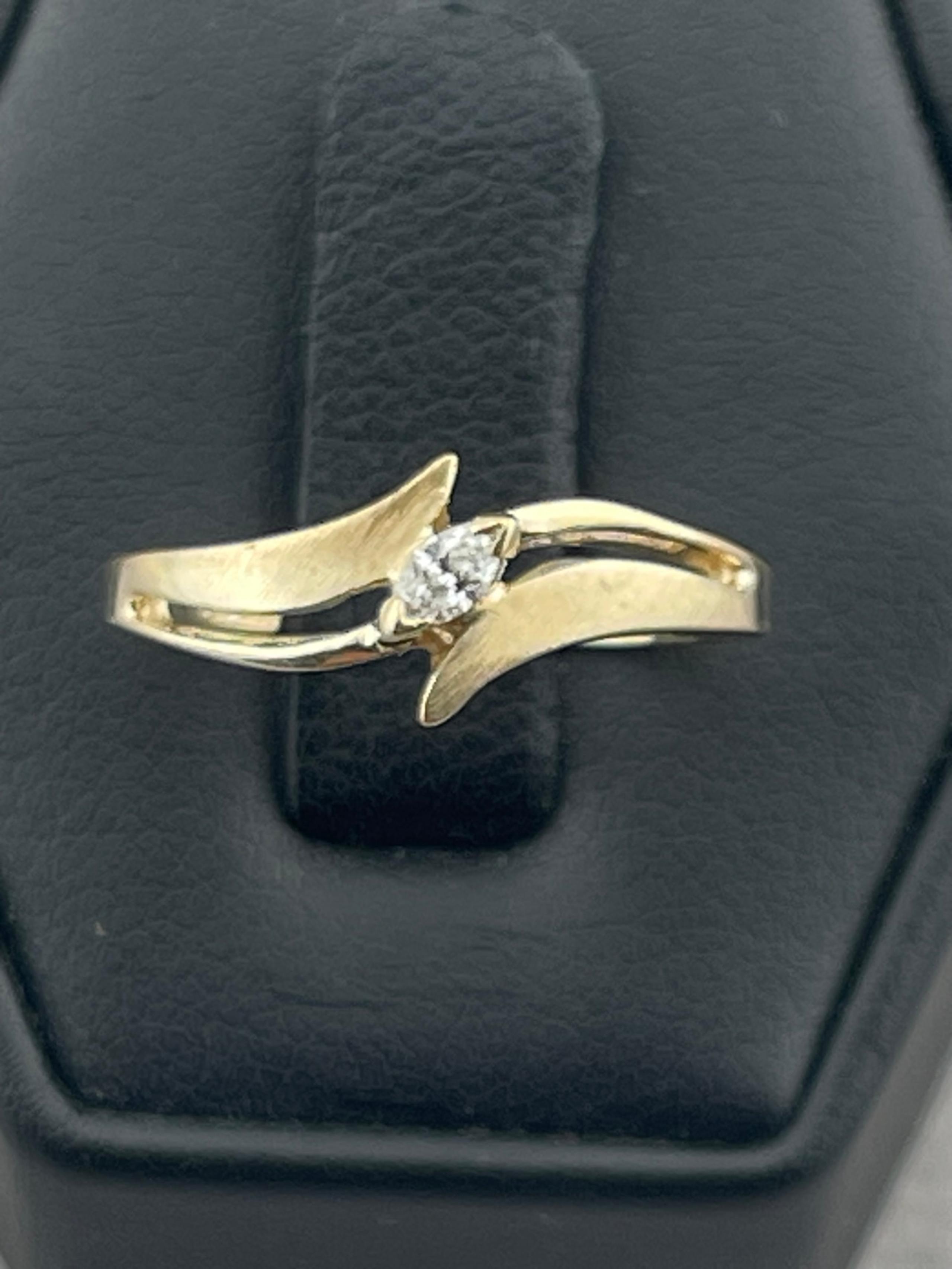 Vintage 1/10 carat marquise diamond bypassing 14 karat yellow gold