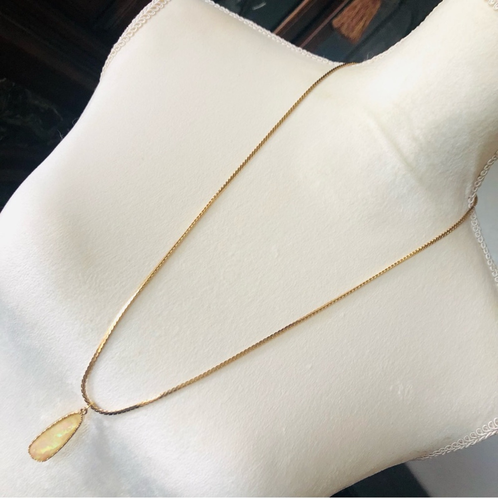 Faceted long raindrop shape simulated opal pendant gold tone necklace
